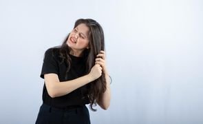 photo brunette girl holding her hair grey 1